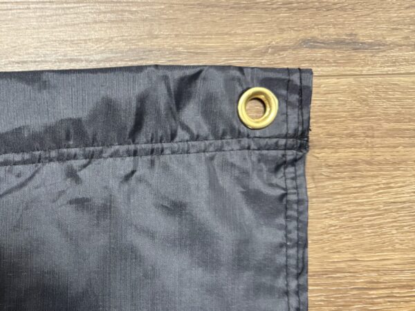 Black fabric with grommet detail.