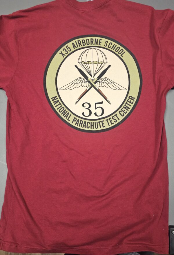 Red t-shirt with parachute school logo.