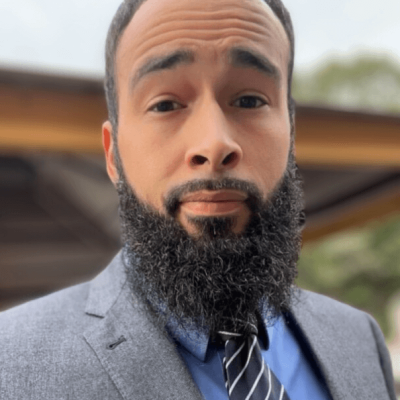 A man with a beard and suit jacket